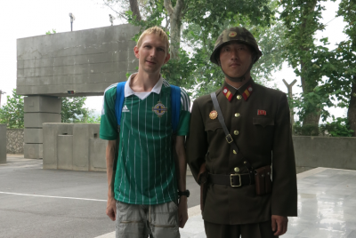 Posing with a North Korean soldier.