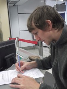 Jonny Blair filling in a Chinese Visa application living a lifestyle of travel