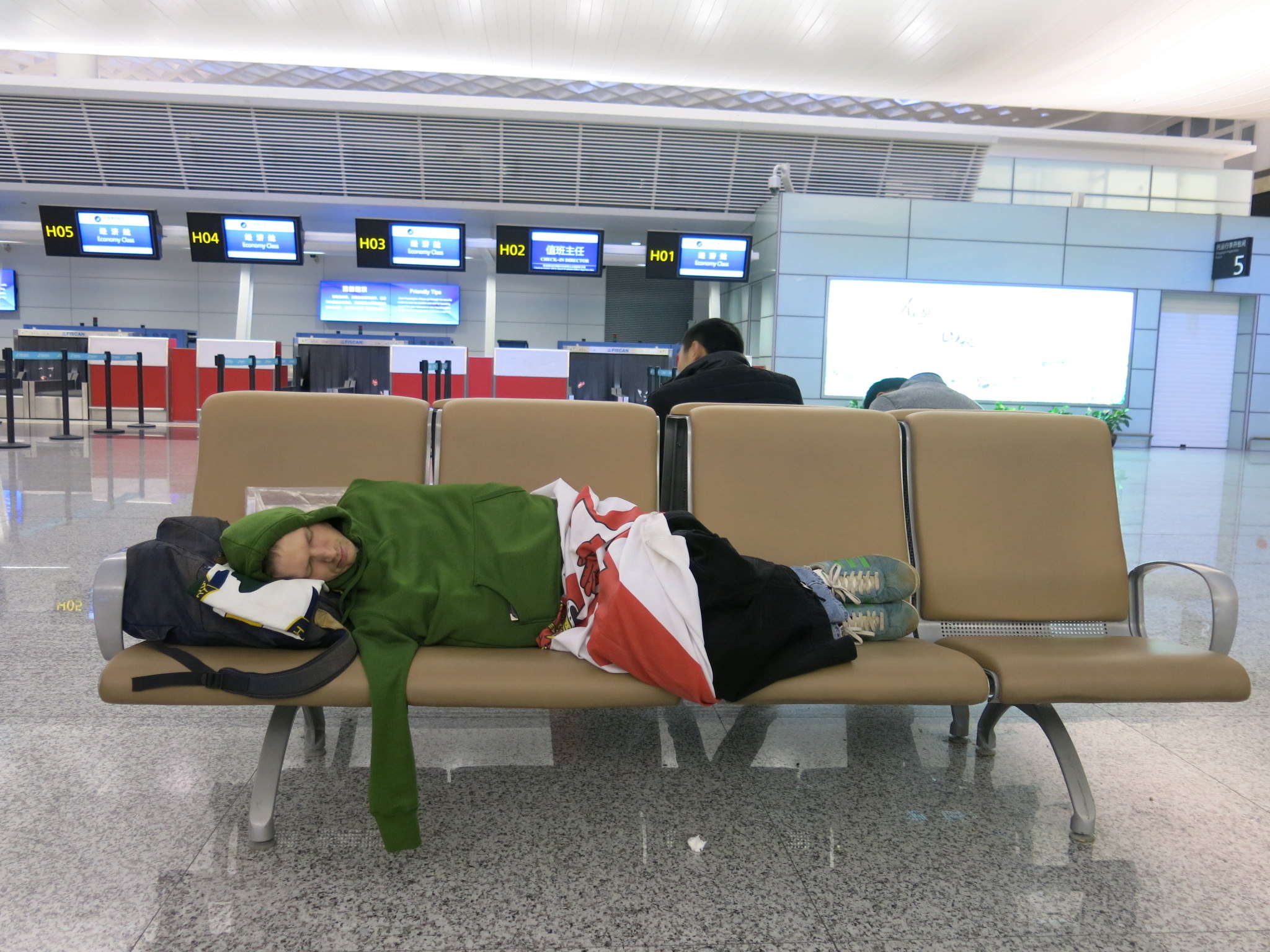 Jonny Blair sleeping in Hangzhou Airport