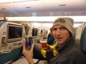 Jonny Blair with a free beer on Singapore airlines