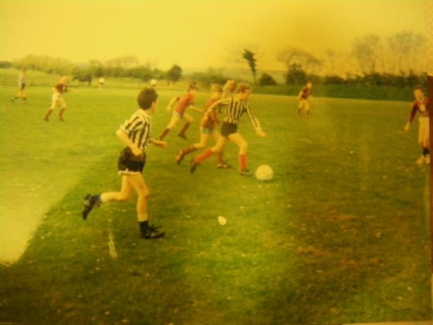 A photo of me playing football aged 11 (I'm the guy chasing the player on the ball. I went un-noticed.