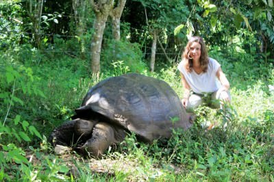 Annette White with a giant tortoise in the Galapagos Islands, Ecuador.