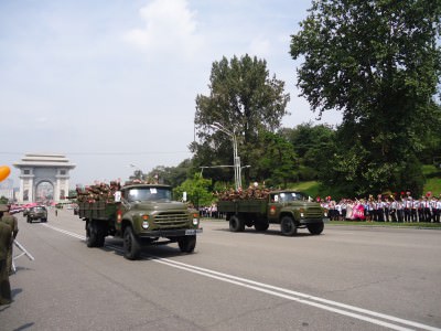 The army parade gets underway as locals line the avenue.