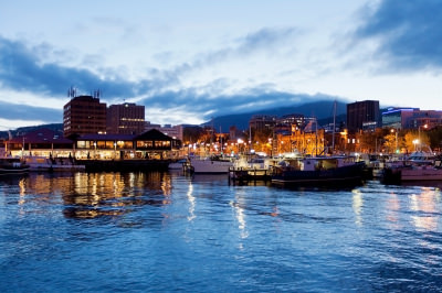Hobart waterfront photographed at night with city skyline and fishing boats