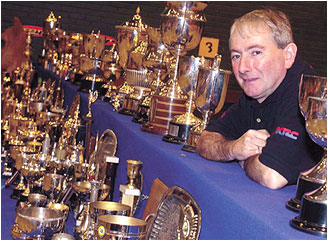 Northern Irish motorcycle legend Joey Dunlop with some of his trophies.