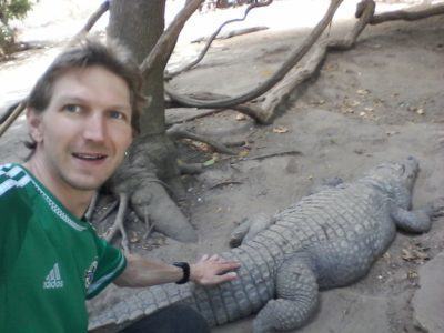 Touching a crocodile at Kachikally