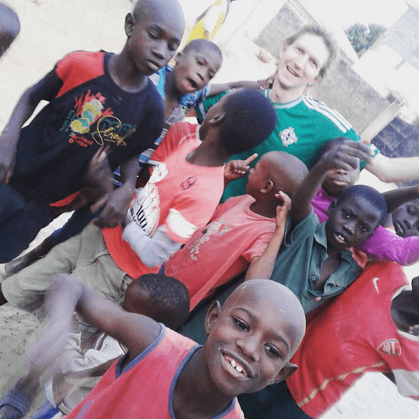Jonny Blair playing football with kids in Africa