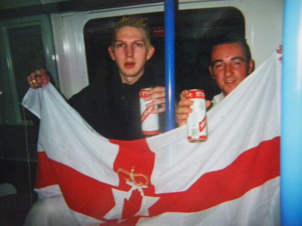 Gavin and I flying the Northern Ireland flag and drinking Reddy S (Red Stripe) on the tube