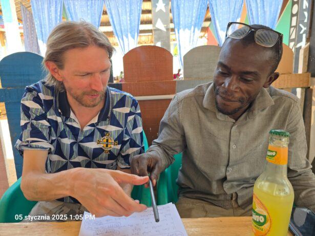 Tognama and I travel writing and chatting at Lunch At Bar Pierre D'Onyx, Near Boali Falls